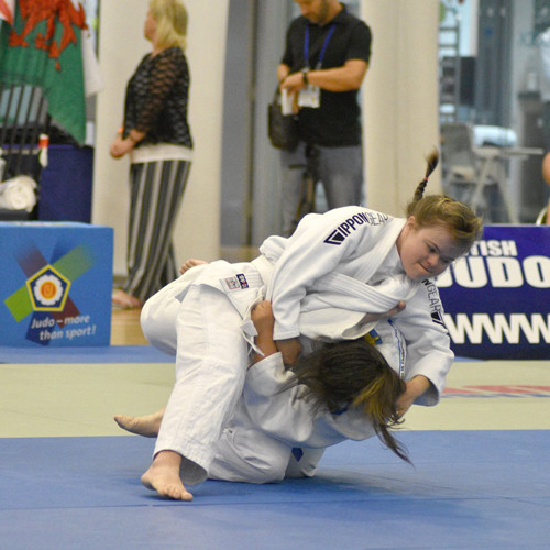 Two Judo fighters in mid grapple.