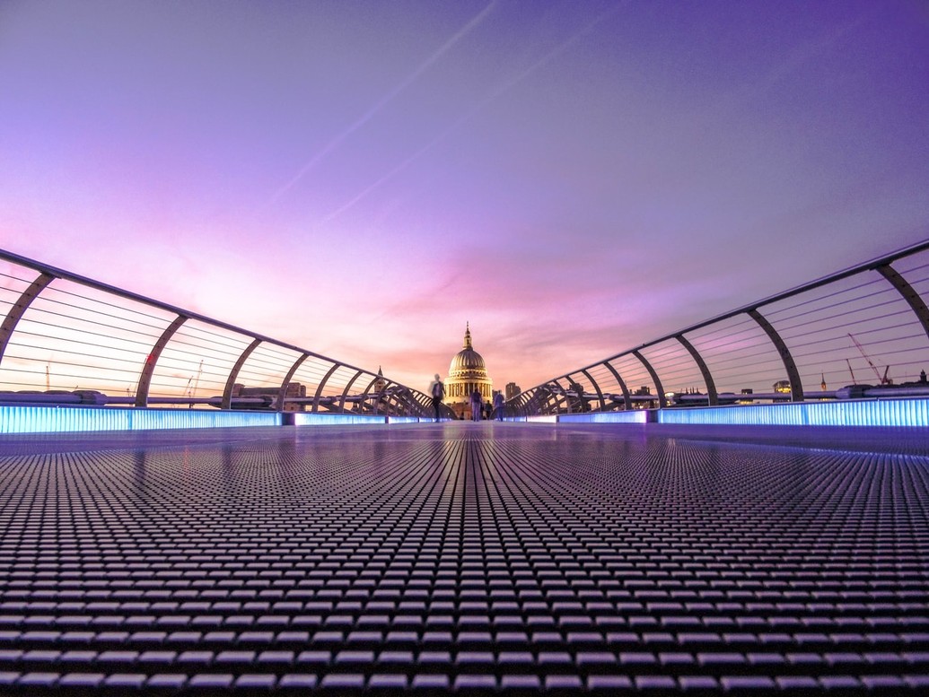 Millennium Bridge photographed against a purple sky