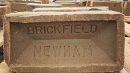 Brick with the words 'Brickfield Newham' engraved on it