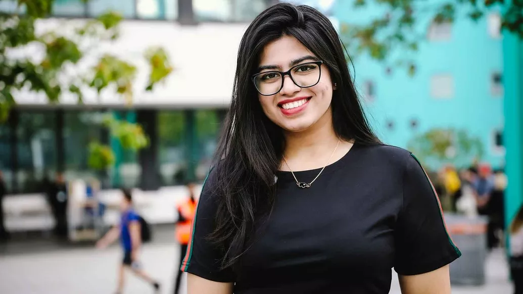 One female student smiling at open day